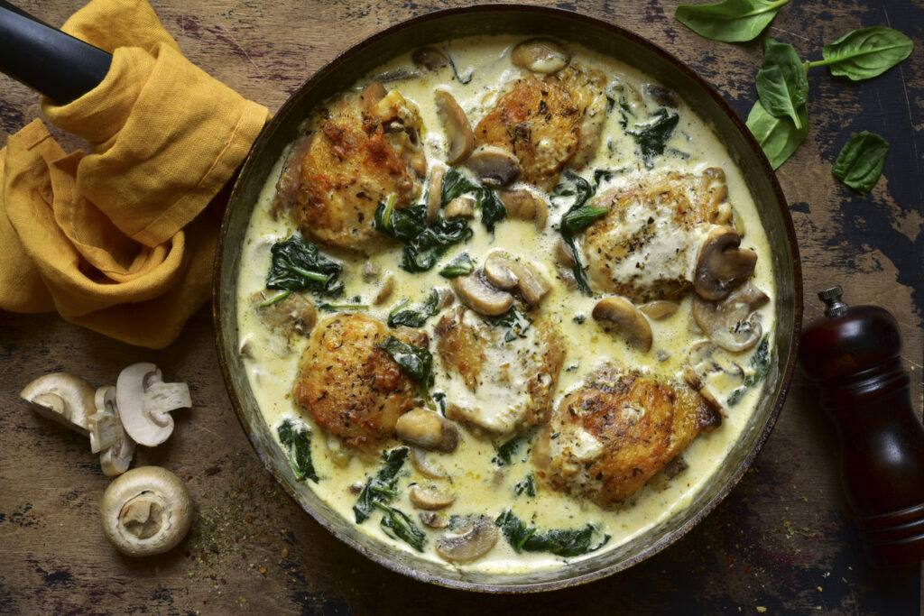 Chicken thighs stewed with mushrooms and spinach in a cream sauce.